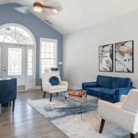 a leasing office with a couch, desk and chairs